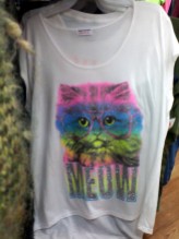 T-shirt with sparkly, bespectacled, neon-rainbow cat saying "Meow."