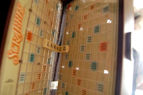 Travel Scrabble Board folded with "JAMMED" in the crease