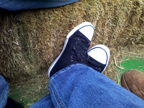 Sneakered feet on hayride